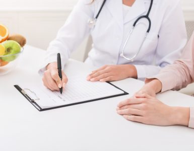 Nutritionist explaining personalized diet plan for patient during appointment in clinic, copy space